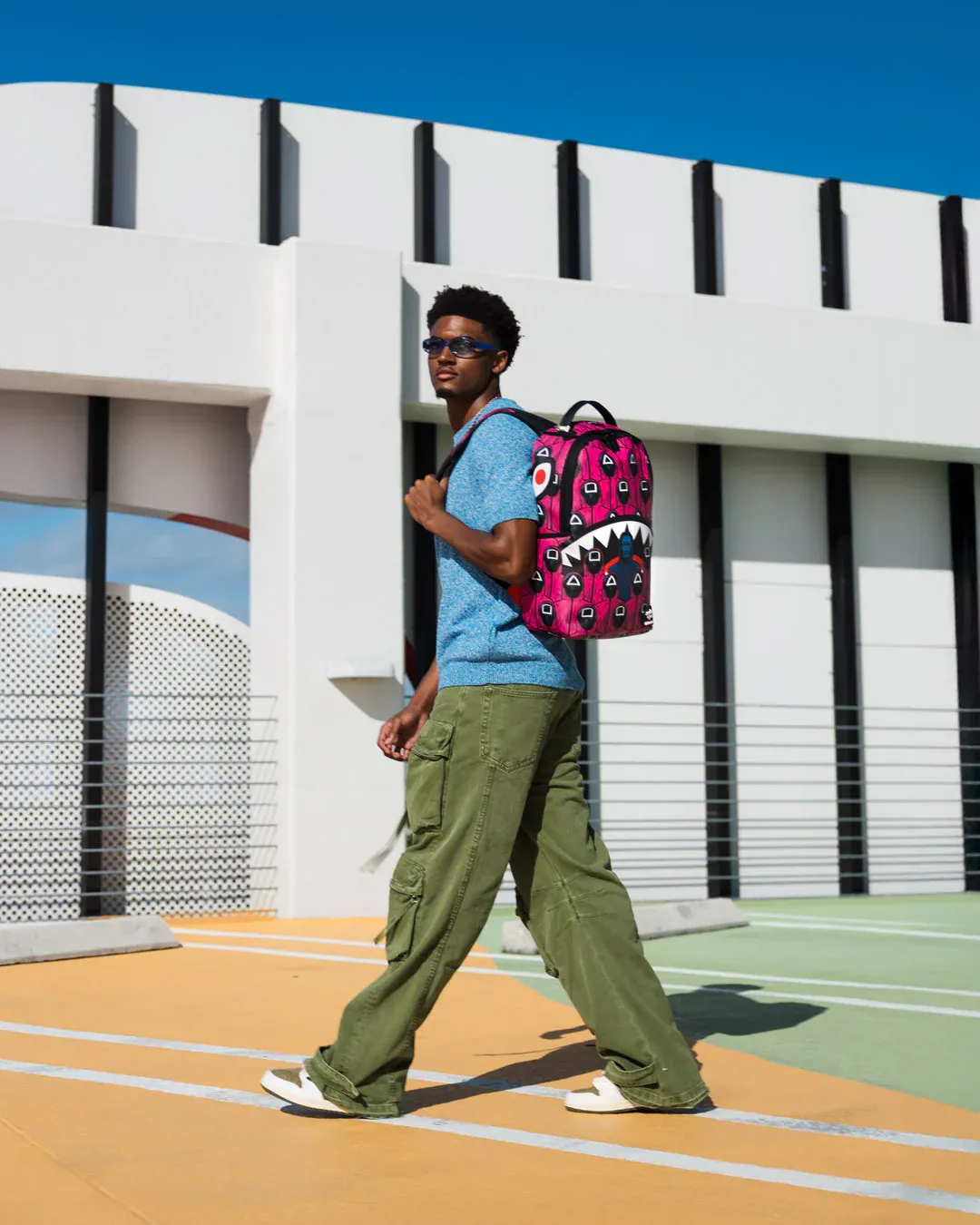 Sprayground X Squid Game Lined Up Front Man & Pink Guard Shark DLXSV Backpack